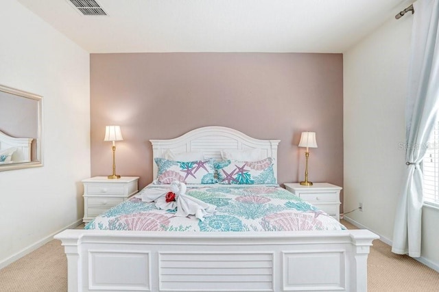 bedroom with light colored carpet