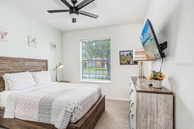 bedroom with light carpet and ceiling fan