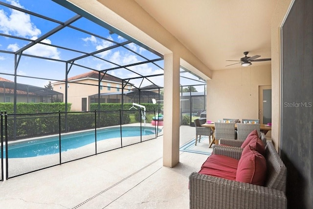 view of pool with a patio, a lanai, and ceiling fan