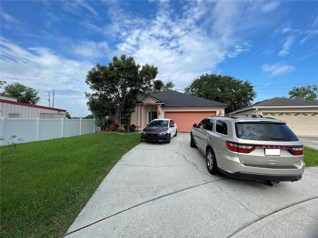 view of front of property featuring a front lawn and a garage