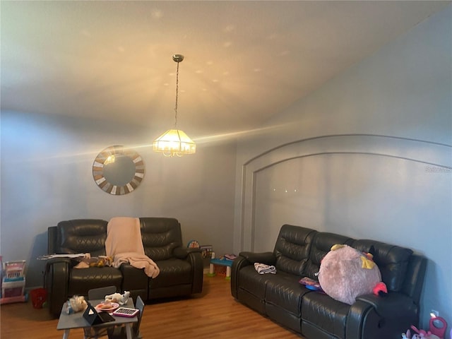 living room featuring a chandelier and light wood-type flooring