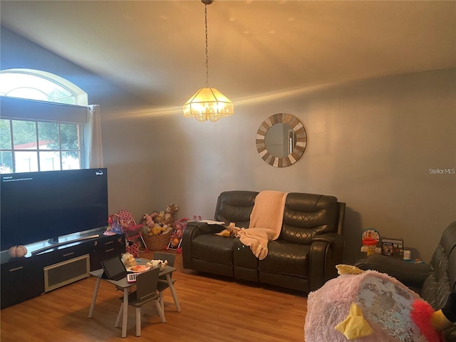 living room with hardwood / wood-style floors and a notable chandelier