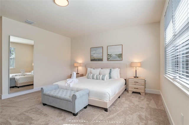 bedroom featuring light colored carpet