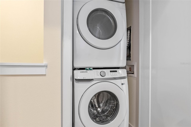 washroom featuring stacked washer and dryer