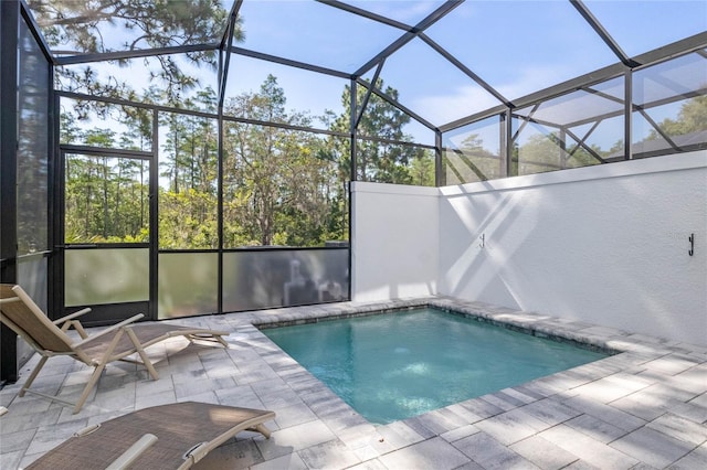 view of swimming pool with a lanai and a patio area