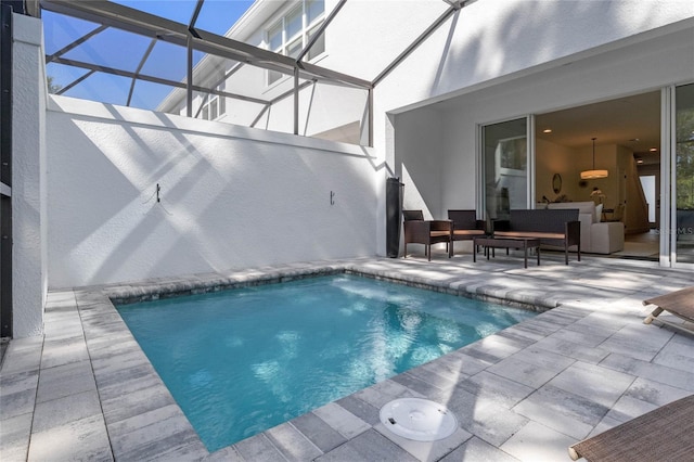 view of swimming pool featuring a patio area and a lanai