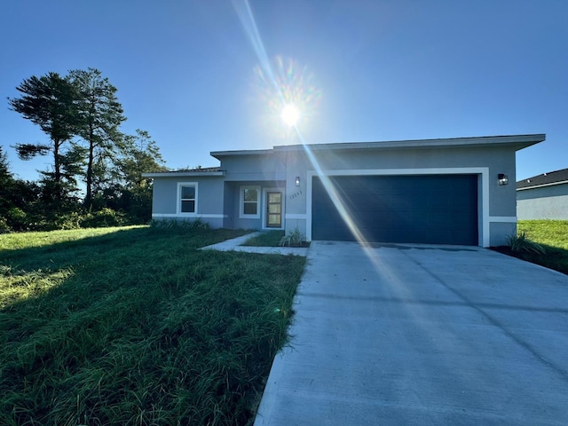 ranch-style home featuring concrete driveway, an attached garage, and stucco siding