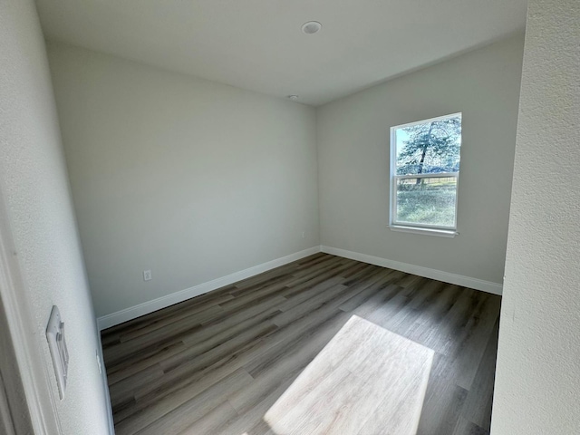 unfurnished room featuring wood finished floors and baseboards