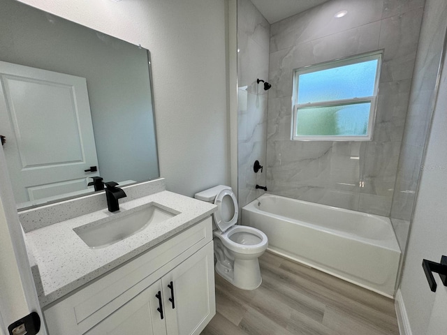 bathroom featuring vanity,  shower combination, toilet, and wood finished floors