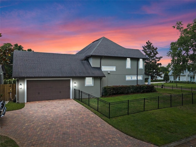 view of front of property featuring a yard and a garage