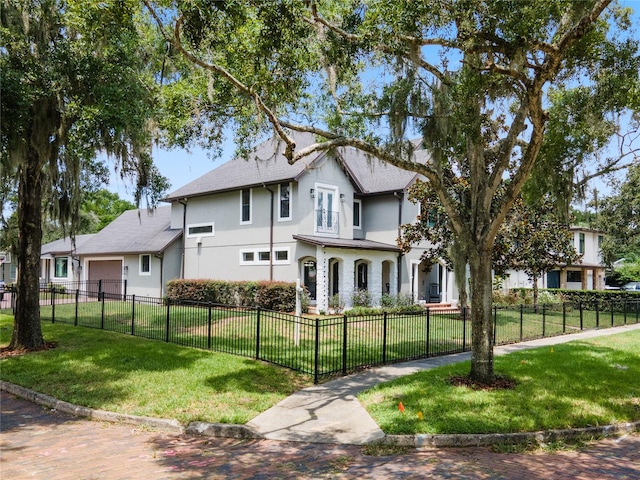 view of front of property with a garage and a front lawn