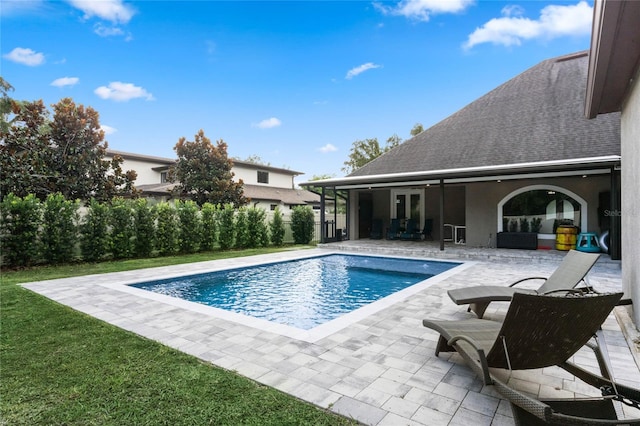 view of pool featuring a patio area and a lawn