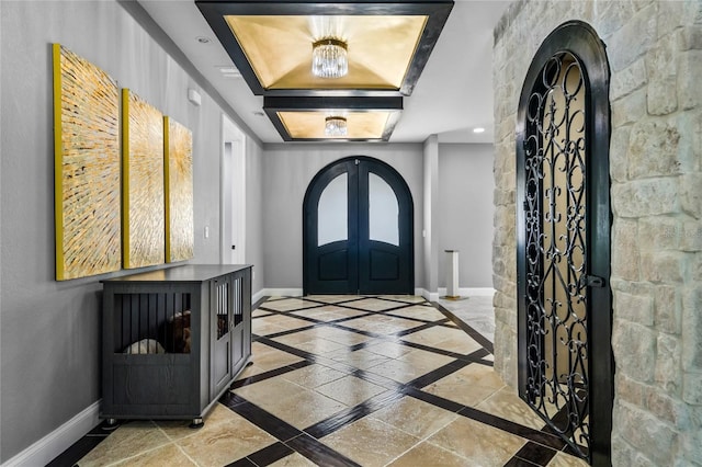 entryway featuring a raised ceiling