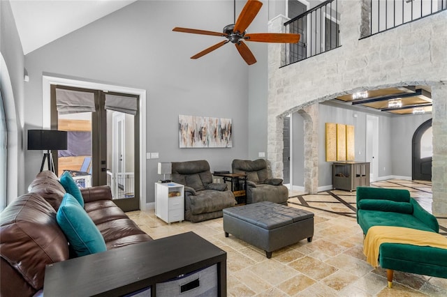 living room with high vaulted ceiling and ceiling fan