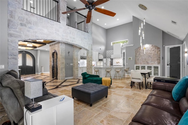 living room with high vaulted ceiling and ceiling fan