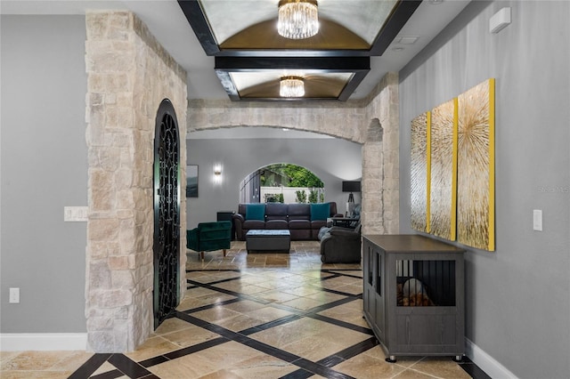 interior space with a chandelier and beamed ceiling