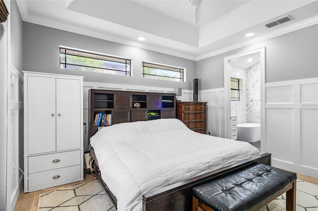 bedroom featuring connected bathroom, ornamental molding, ceiling fan, and light hardwood / wood-style floors