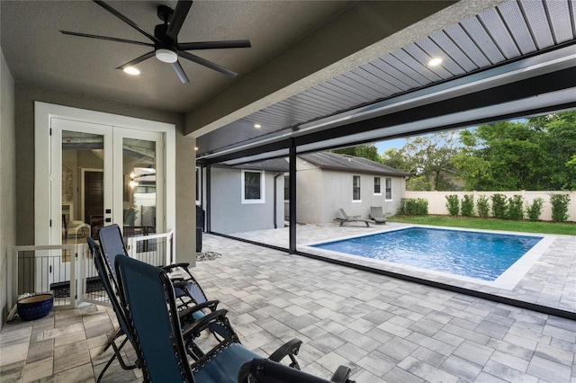 view of swimming pool featuring ceiling fan and a patio area