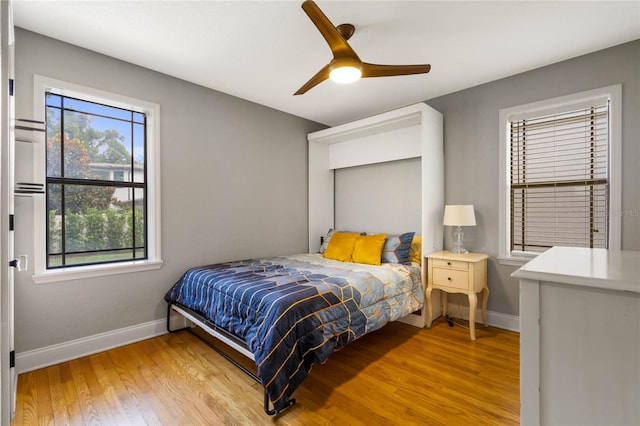 bedroom with light hardwood / wood-style flooring and ceiling fan