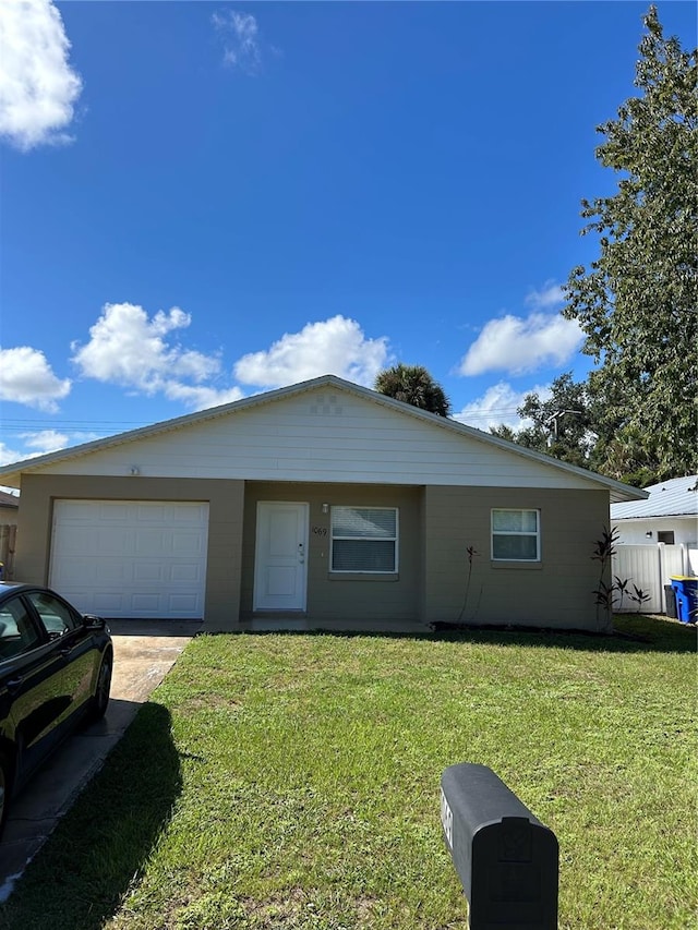 view of front of home with a garage and a front lawn