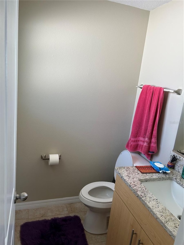 bathroom with tile patterned floors, toilet, and vanity