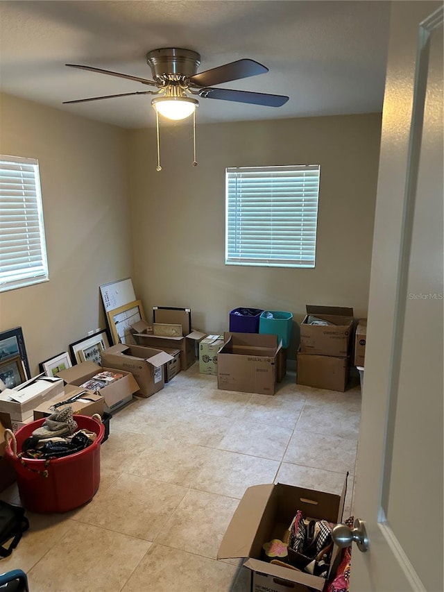 living room featuring ceiling fan and tile patterned floors