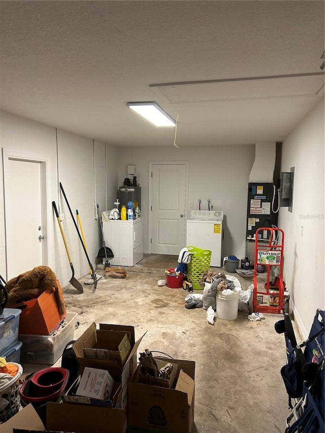 basement with washing machine and clothes dryer, heating unit, and water heater