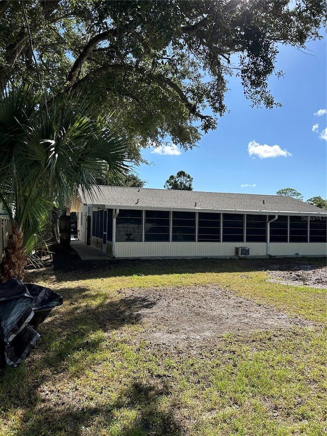 rear view of property featuring a lawn