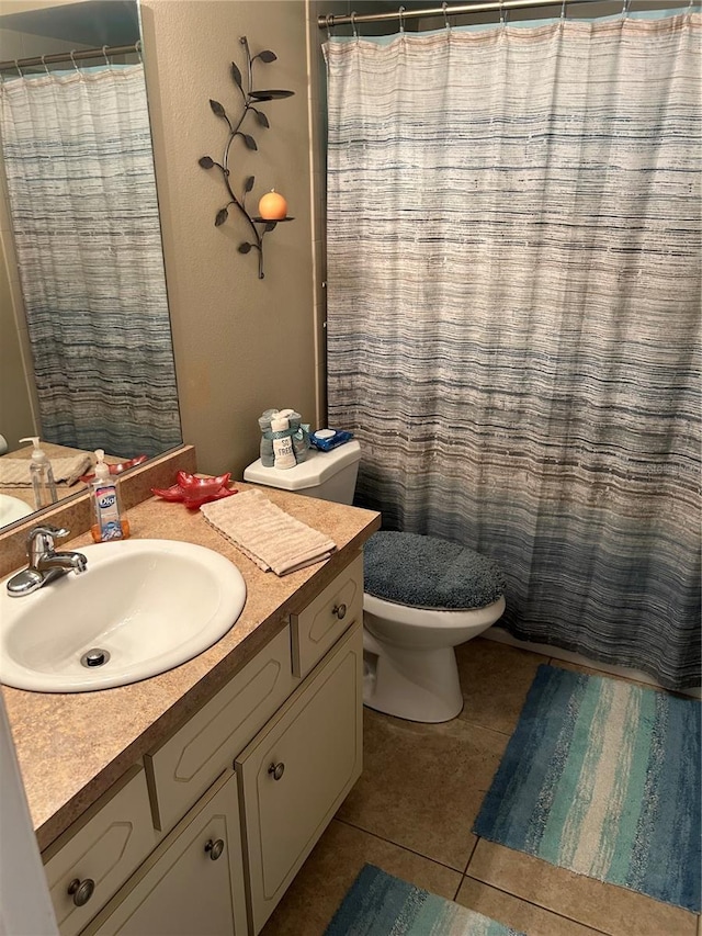 bathroom featuring vanity, toilet, curtained shower, and tile patterned floors