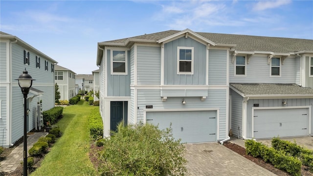 view of front of home featuring a garage and a front lawn