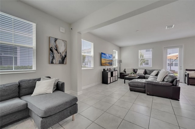 living room featuring a healthy amount of sunlight and light tile patterned floors