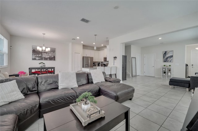 living room with a notable chandelier and light tile patterned floors