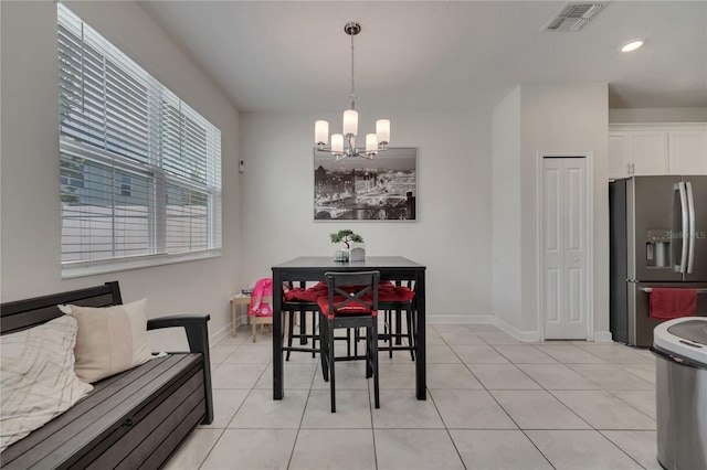 tiled dining area with a notable chandelier