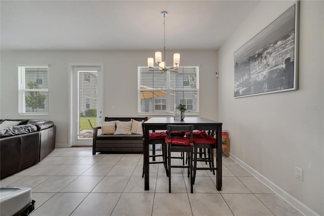 tiled dining room with a wealth of natural light and a chandelier