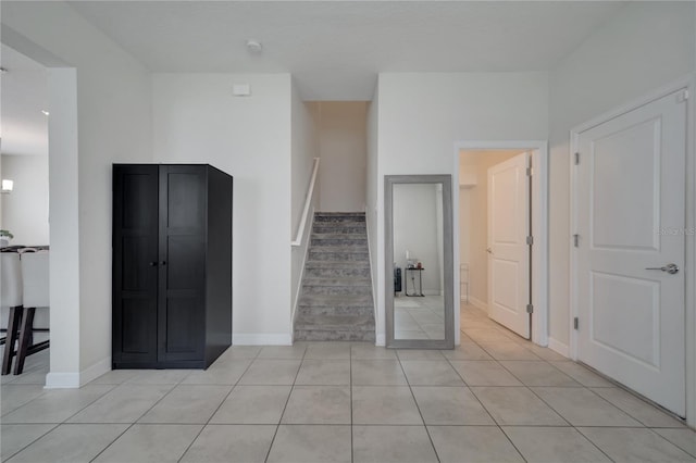 unfurnished living room featuring light tile patterned floors