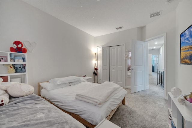 bedroom with light carpet and a closet