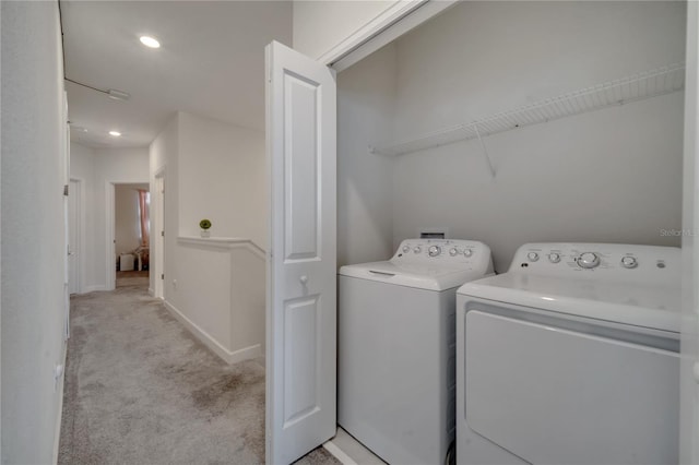 laundry area with light carpet and independent washer and dryer