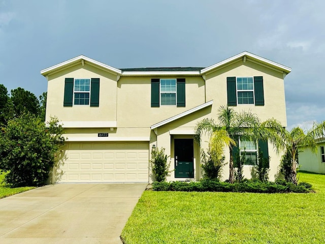 view of front of property featuring a garage and a front lawn