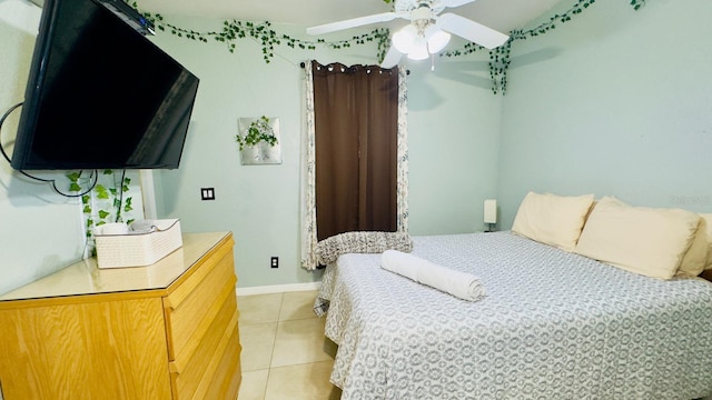 bedroom with light tile patterned flooring, ceiling fan, and baseboards