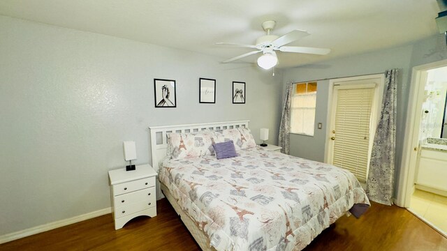 bedroom featuring dark wood-style floors, ceiling fan, and baseboards