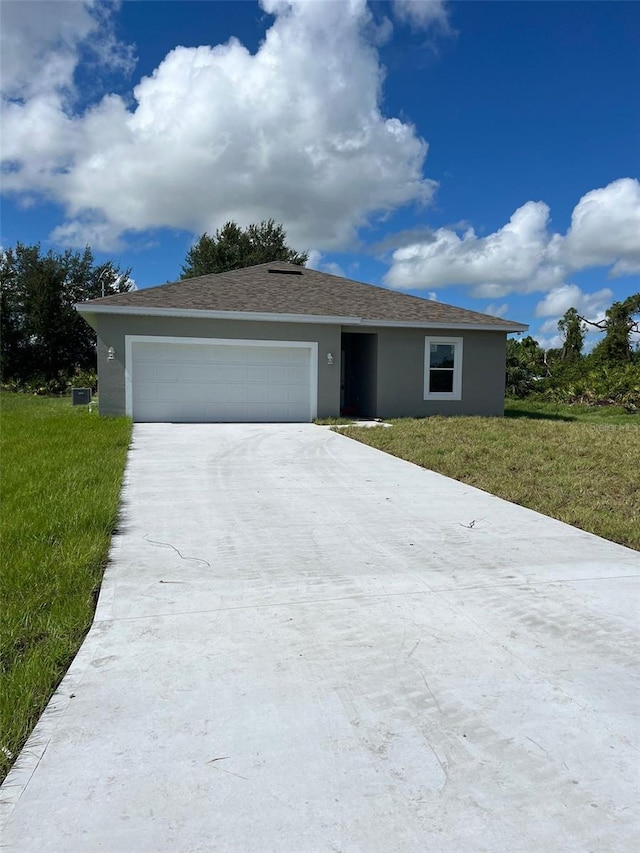 single story home with a garage and a front yard