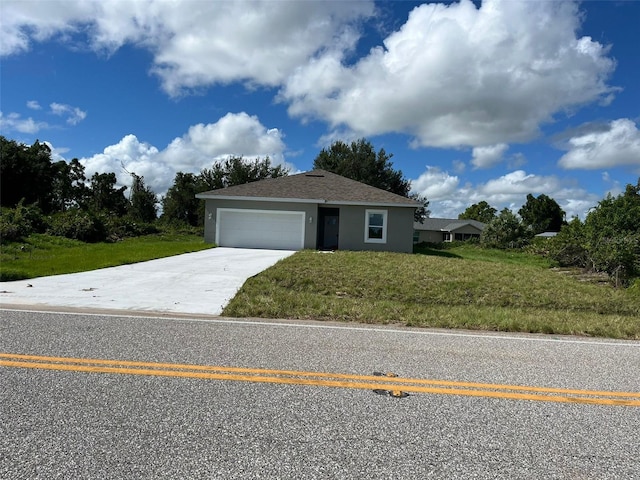 view of front of home featuring a garage and a front lawn