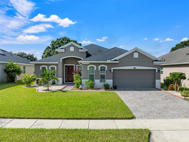 view of front facade with a front lawn and a garage