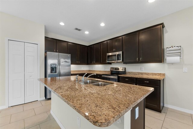 kitchen featuring a kitchen island with sink, appliances with stainless steel finishes, and sink