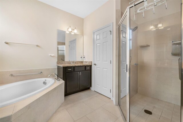 bathroom with vanity, tile patterned floors, and shower with separate bathtub