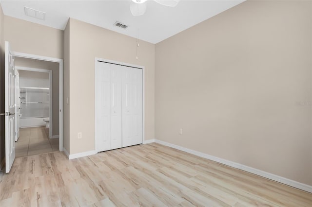 unfurnished bedroom with light hardwood / wood-style flooring, ceiling fan, and a closet