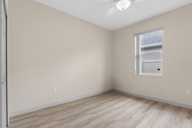 empty room featuring ceiling fan and light hardwood / wood-style flooring