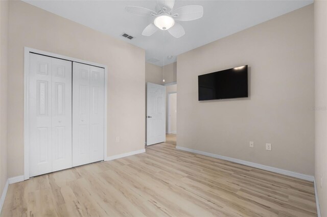 unfurnished bedroom with a closet, ceiling fan, and light hardwood / wood-style floors