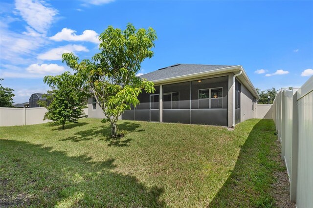 exterior space featuring a sunroom and a lawn