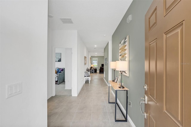 hall featuring light tile patterned floors